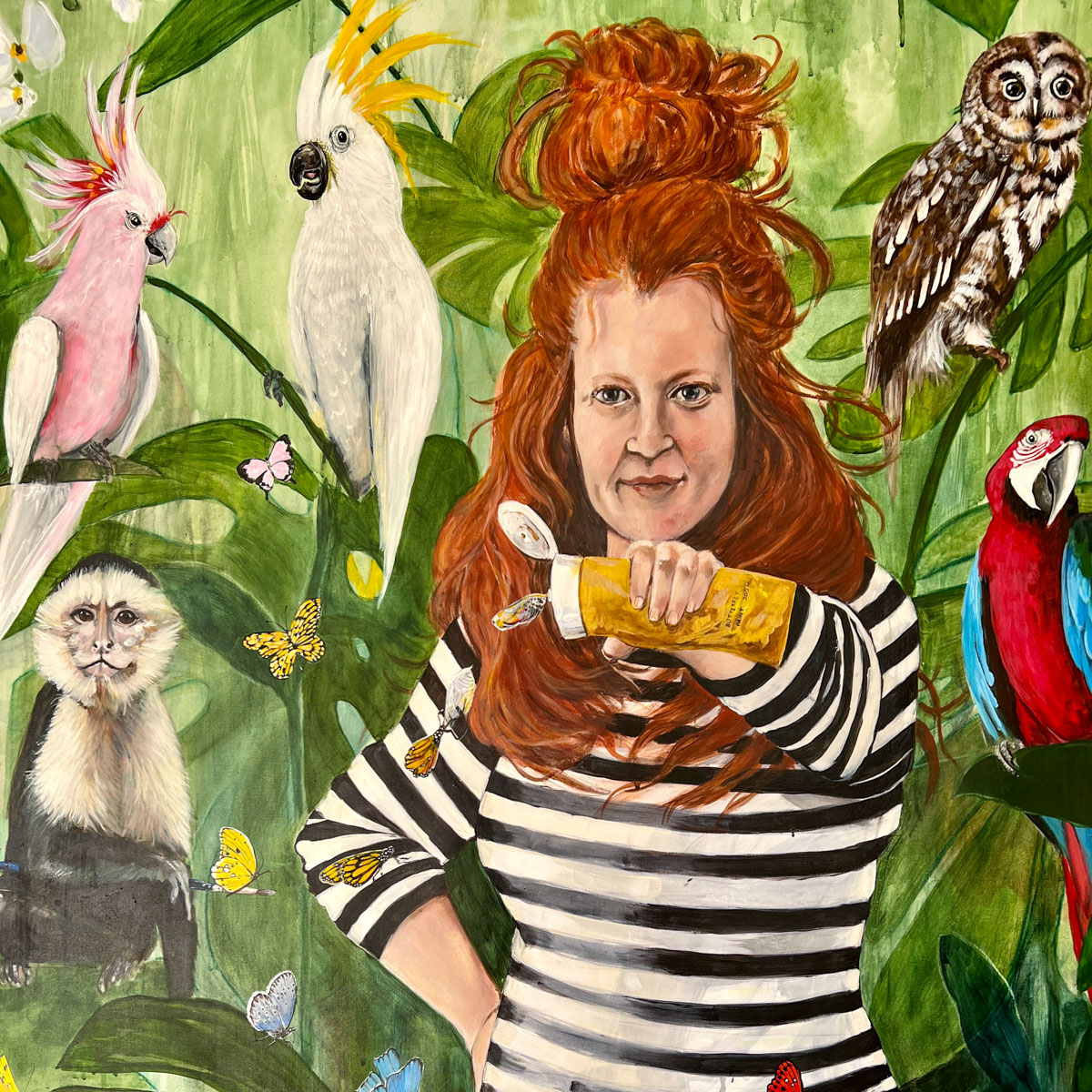 Painting of the artist wearing striped shirt with cockatoos, parot, owl and monkey in a forest - Emma Ward - Draw Creative